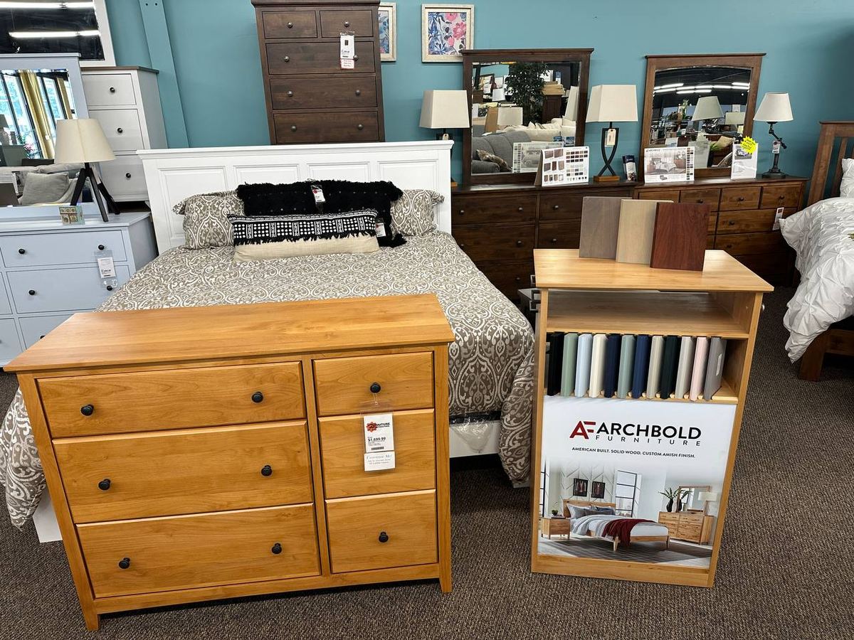 Archbold Furniture custom wood and painted finish samples beside a solid wood chest